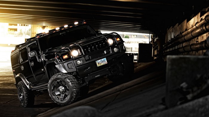Black Hummer SUV Under Urban Bridge