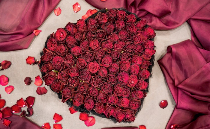 Heart-shaped bouquet of red roses with silk fabric