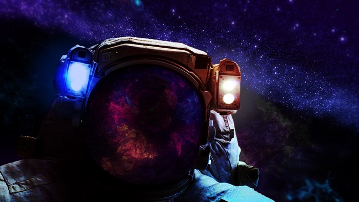 Astronaut in space with galaxy reflection