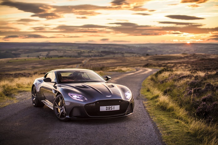 Aston Martin DBS Superleggera on a winding road at sunset