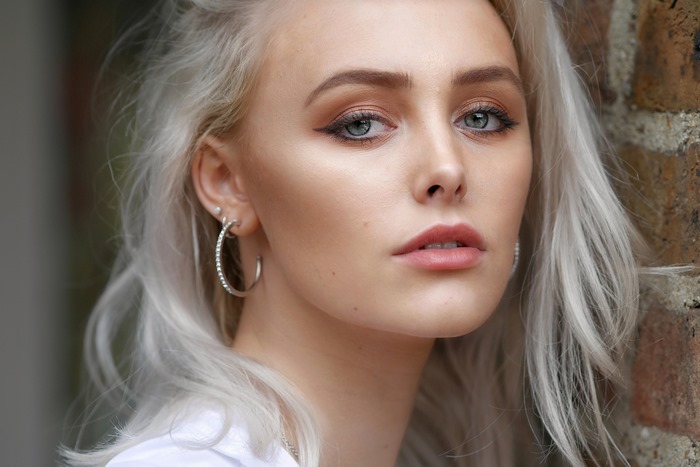 Portrait of a Blonde Girl with Blue Eyes and Earrings