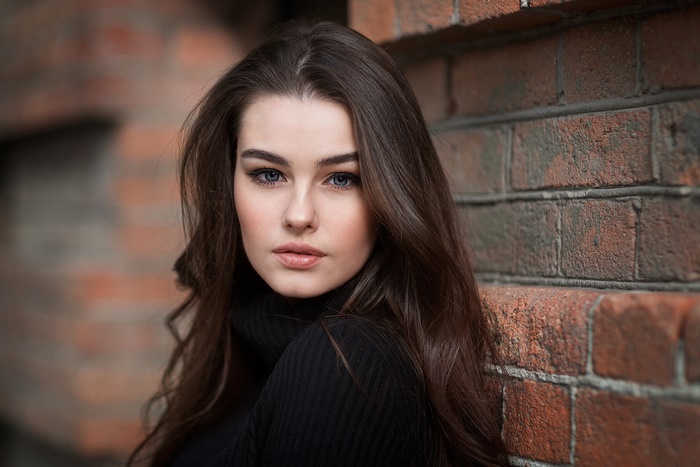 Woman with long brown hair and blue eyes