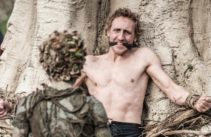 Man tied to tree by Children of the Forest