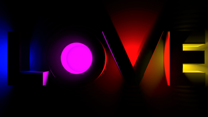The word LOVE illuminated by colorful neon lights