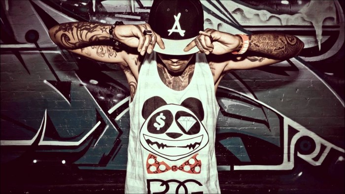 Man in tank top and cap with tattoos