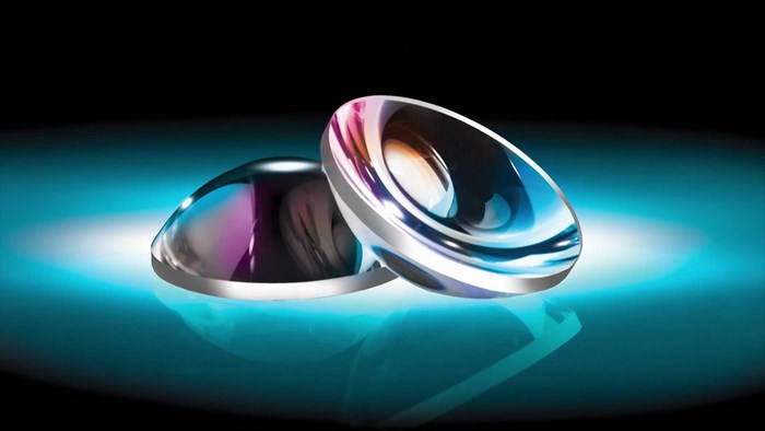 Two optical lenses with iridescent reflections