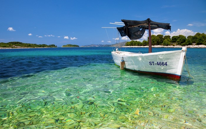 White boat with ST-4664 marking in clear turquoise water