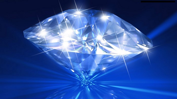 Diamond on blue background with light rays