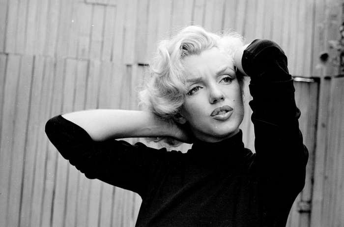 Marilyn Monroe posing with hands behind head