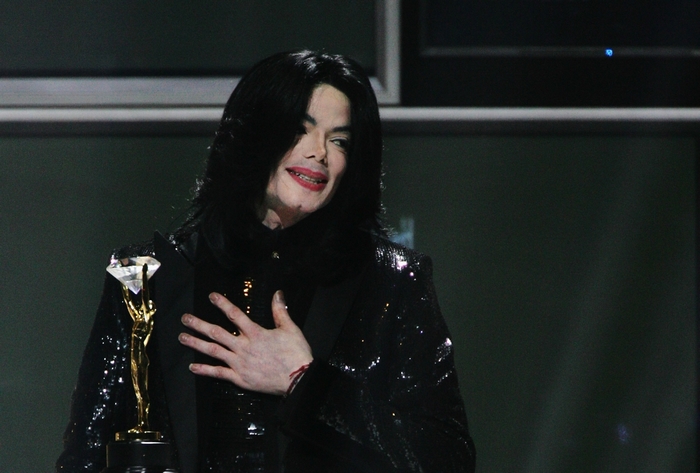 Michael Jackson holding a diamond award