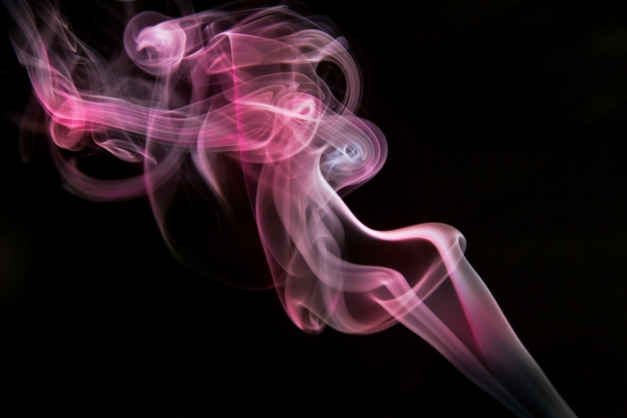 Pink smoke wisps against black background