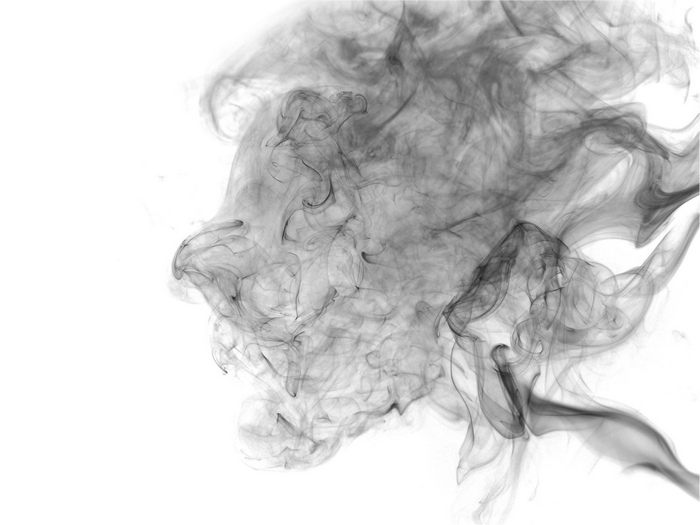 Abstract black smoke swirls on white background