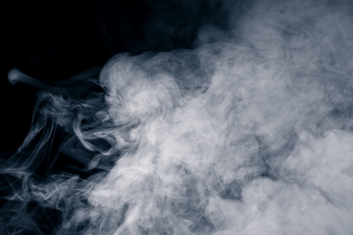 Smoke wisps against a black background