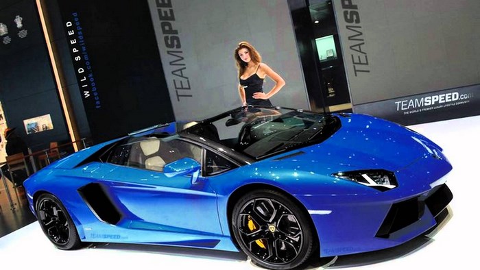 Blue Lamborghini Aventador with a woman and TEAMSPEED logo