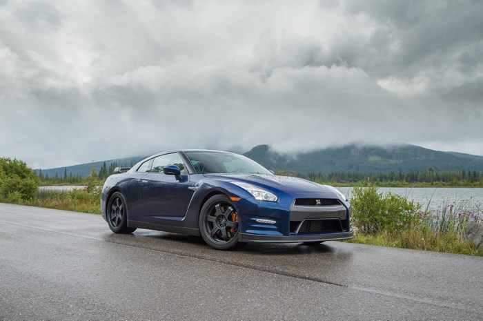 Blue Nissan GT-R parked on a wet road