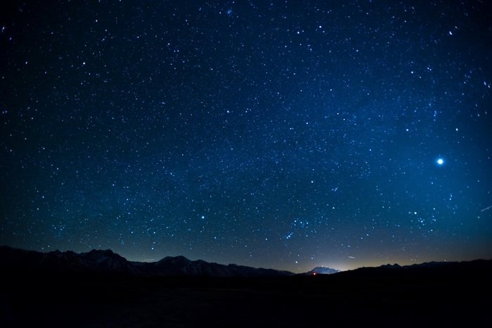 Starry night sky over mountains