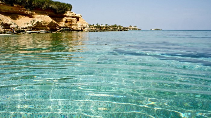 Crystal clear water by a rocky coastline