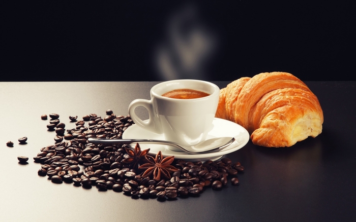 Espresso coffee with croissant and coffee beans