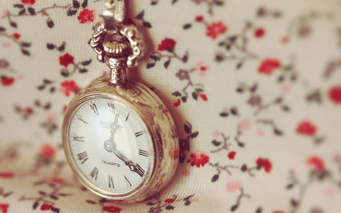 Vintage pocket watch on floral fabric