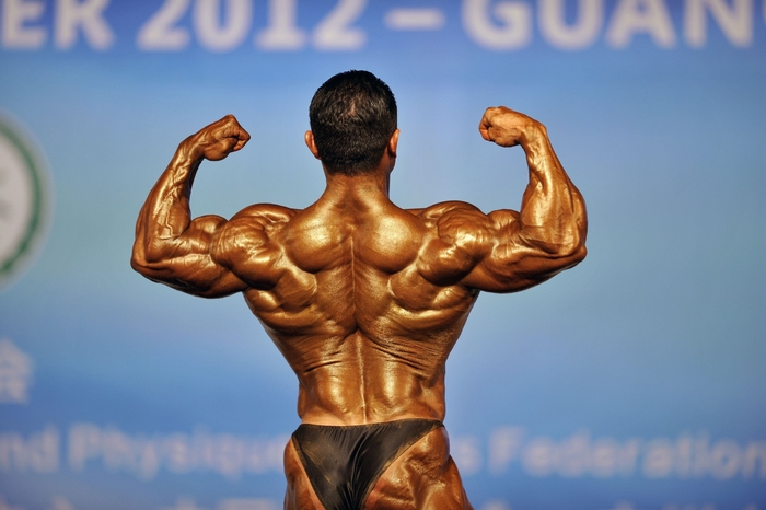 Bodybuilder flexing back muscles