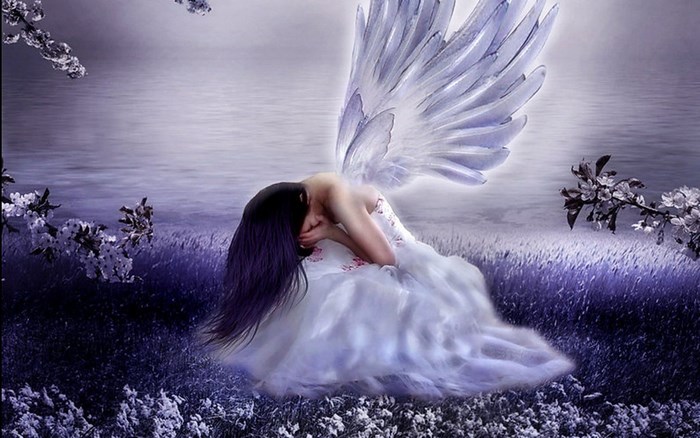 Angel sitting in a field by the water