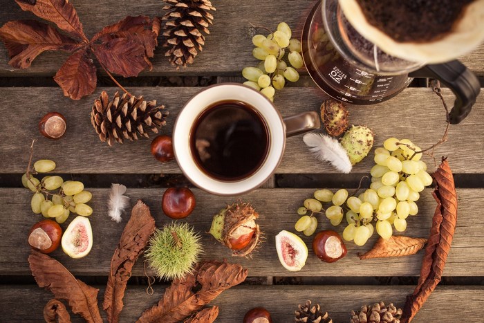 Autumn coffee and fruits on a wooden table