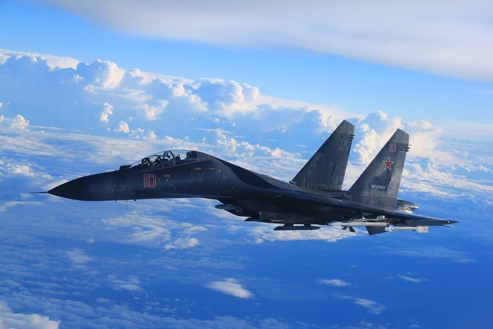 Sukhoi Su-35 fighter jet flying above clouds