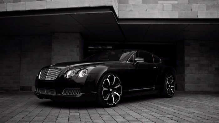 Black Bentley Continental GT parked under a building