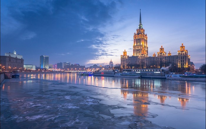 Moscow skyline with frozen river at dusk