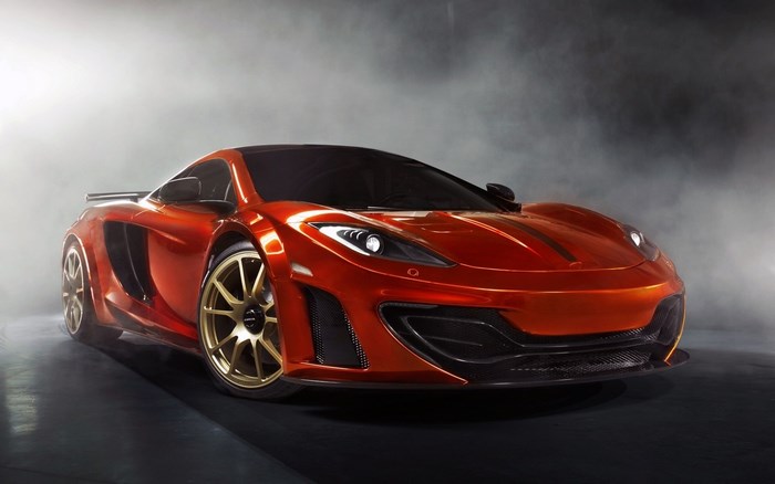 Orange McLaren sports car with gold wheels