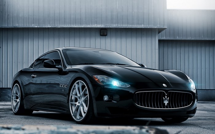 Black Maserati GranTurismo parked in front of a building