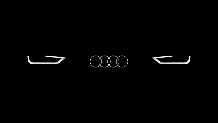 Audi logo and car lights on black background