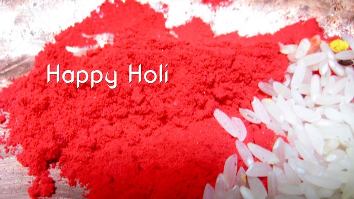Happy Holi red powder and rice