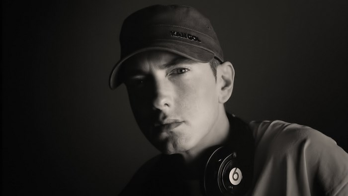Eminem wearing a Kangol hat and Beats headphones
