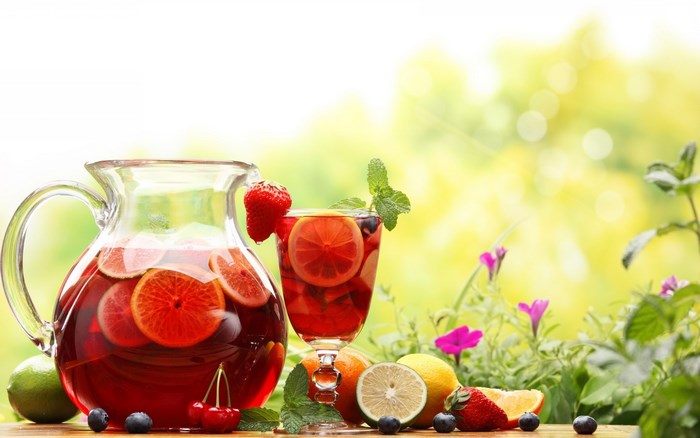 Pitcher and glass of fruit punch with fruits