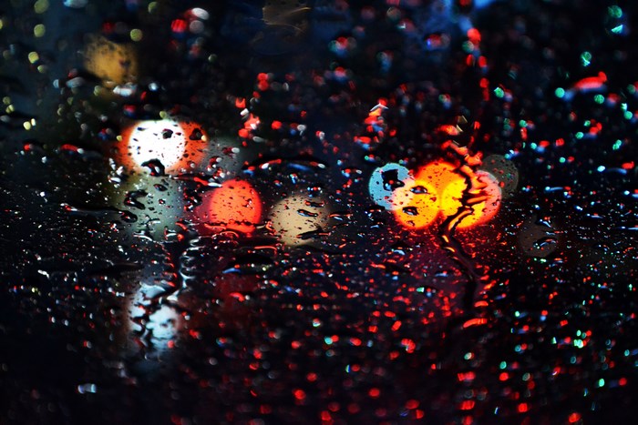 Raindrops on glass with bokeh lights