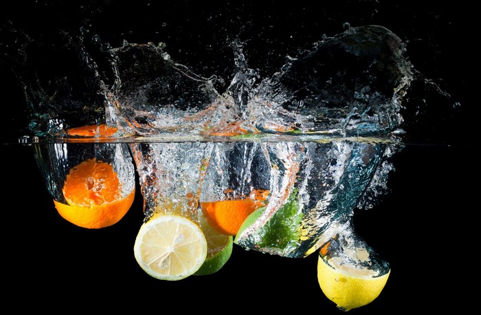 Citrus Fruits Splashing into Water