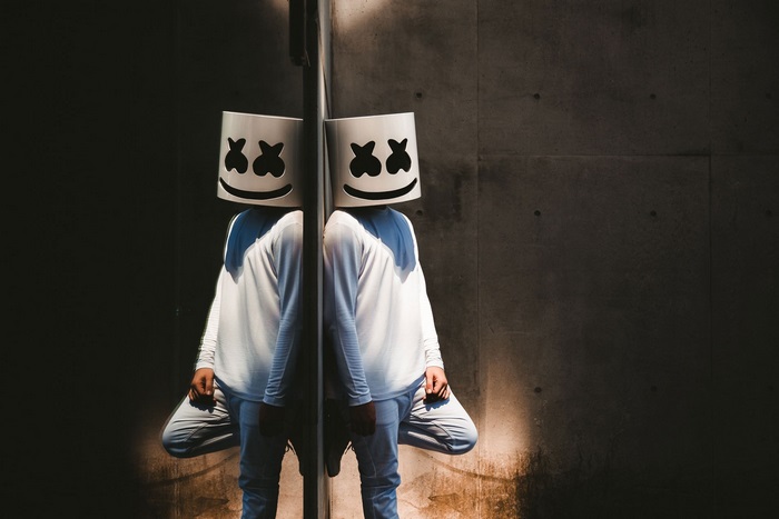 Marshmello reflected against a concrete wall