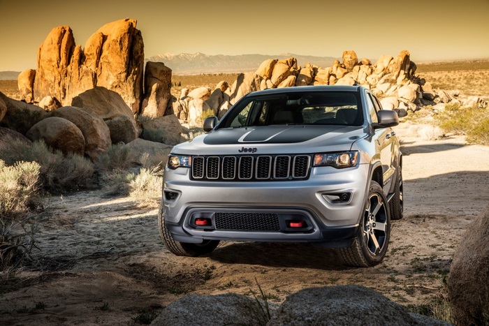 Silver Jeep Grand Cherokee in a desert landscape