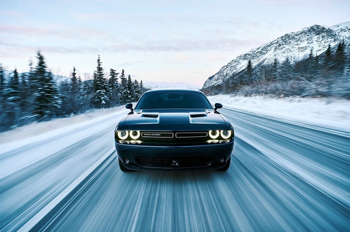 Dodge Challenger GT AWD driving on a snowy road