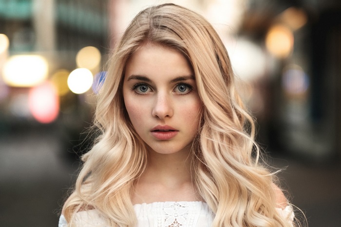 Blonde Woman with Wavy Hair in Urban Setting