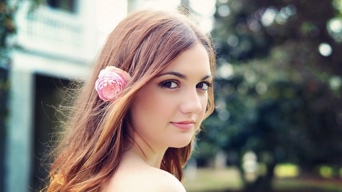 Young woman with flower in hair, 4K