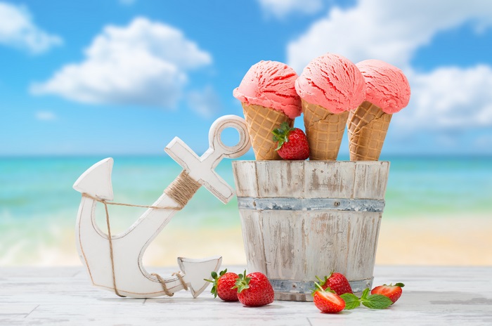 Strawberry ice cream cones on a beach