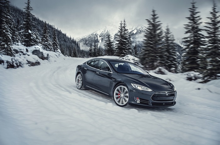 Tesla Model S P85D driving on a snowy mountain road