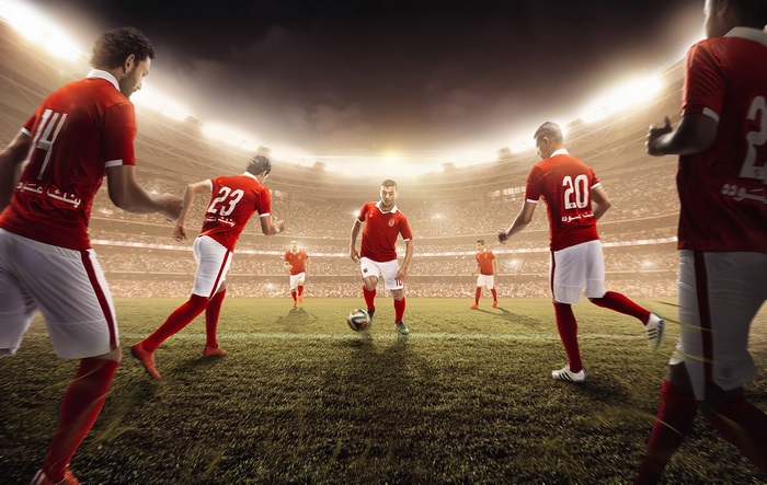 Football team playing in a stadium 4K