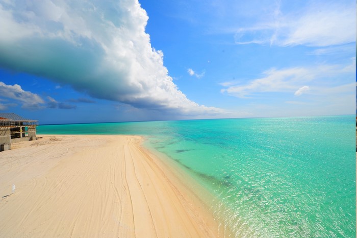 Beach with turquoise water and construction site