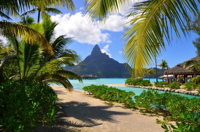 Tropical Bora Bora resort with mountain and palm trees