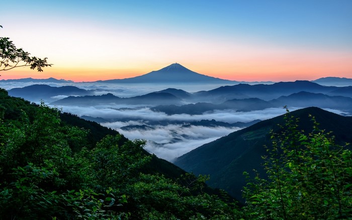 Mount Fuji at sunrise over a sea of clouds