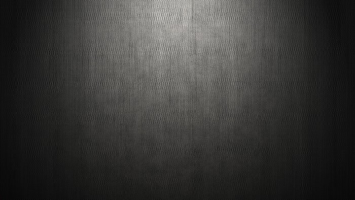 Abstract dark gray textured background with light spotlight