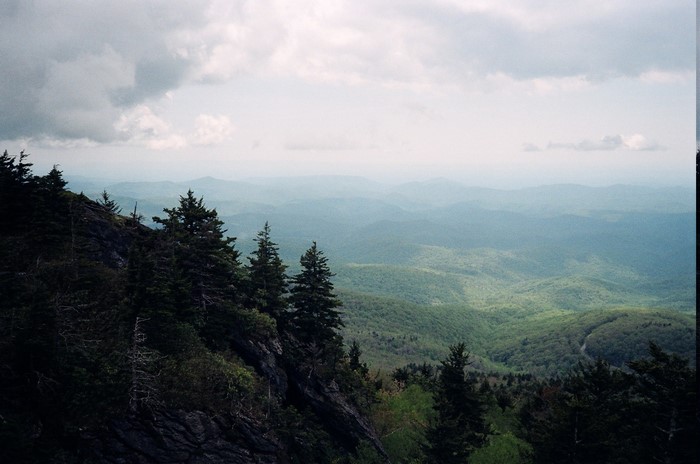 Mountain landscape with trees and clouds